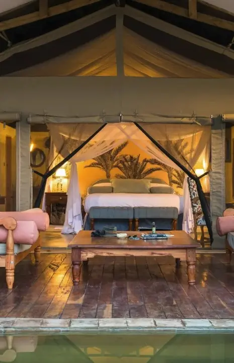 Luxury safari tent bedroom with twin daybeds and pool view, The River Station, Queen Elizabeth NP, Uganda