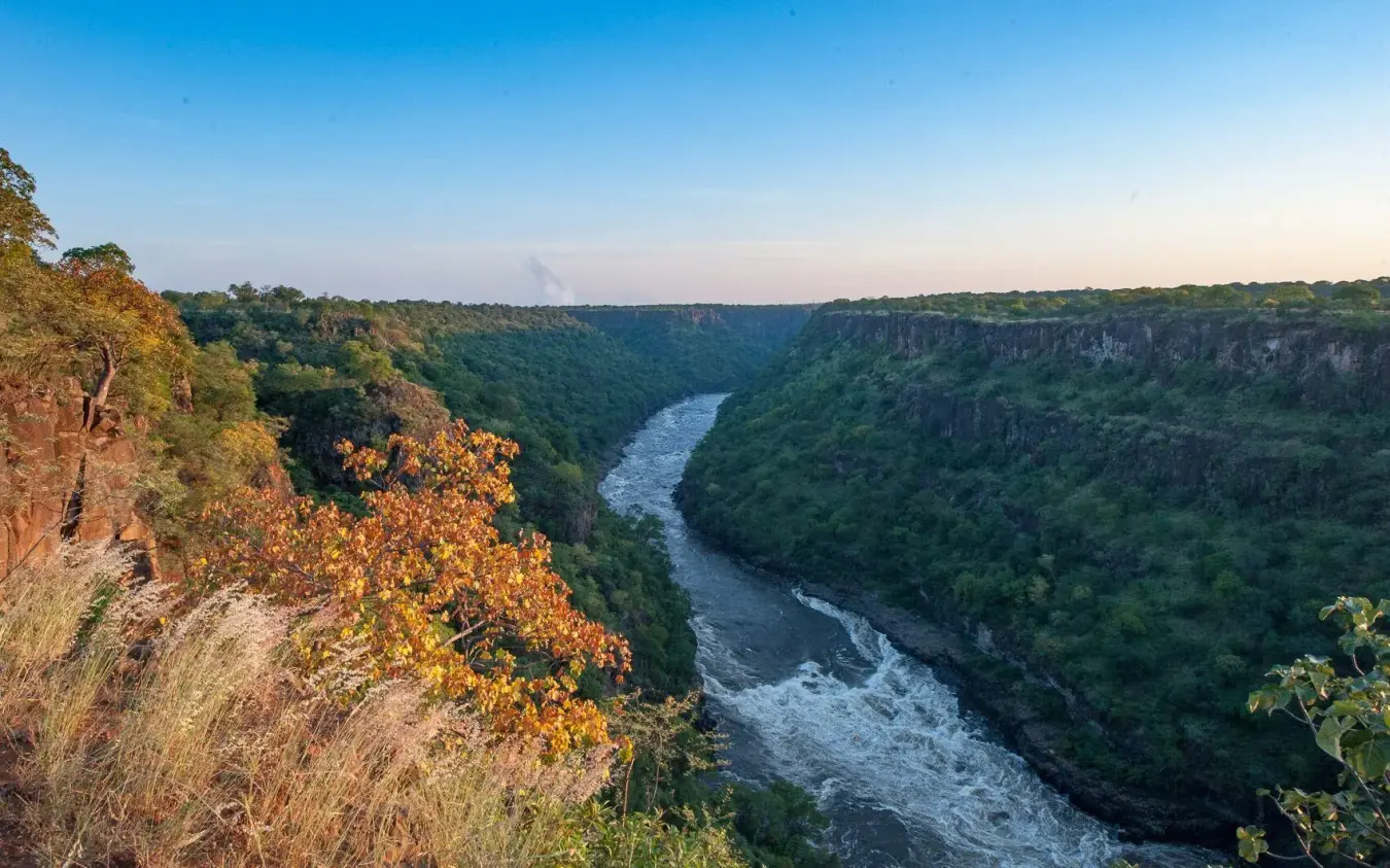 River canyon with lush vegetation and rocky cliffs, The Wallow Lodge, Hwange National Park, Zimbabwe