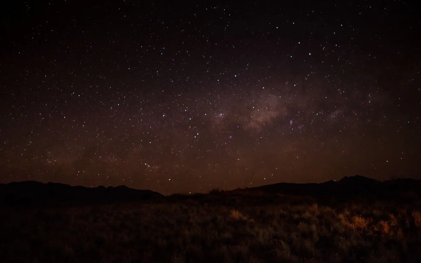 Milky Way galaxy stretching across desert night sky, Tok Tokkie Trails, NamibRand Private Reserve, Namibia