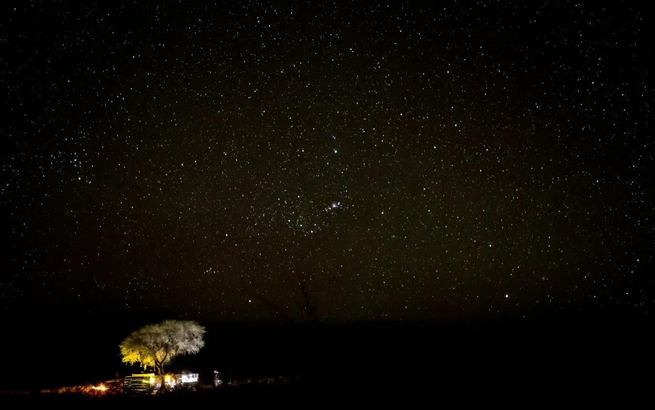 Illuminated lodge beneath starry night sky, Tok Tokkie Trails, NamibRand Private Reserve, Namibia