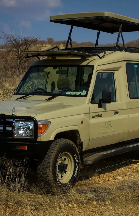Safari vehicle parked in African savanna landscape, Swakopmund, Namibia