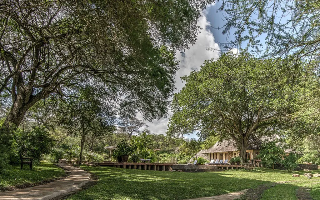 Manicured grounds with trees and colonial-style building, Umani Springs, Amboseli and Chyulu Hills, Kenya
