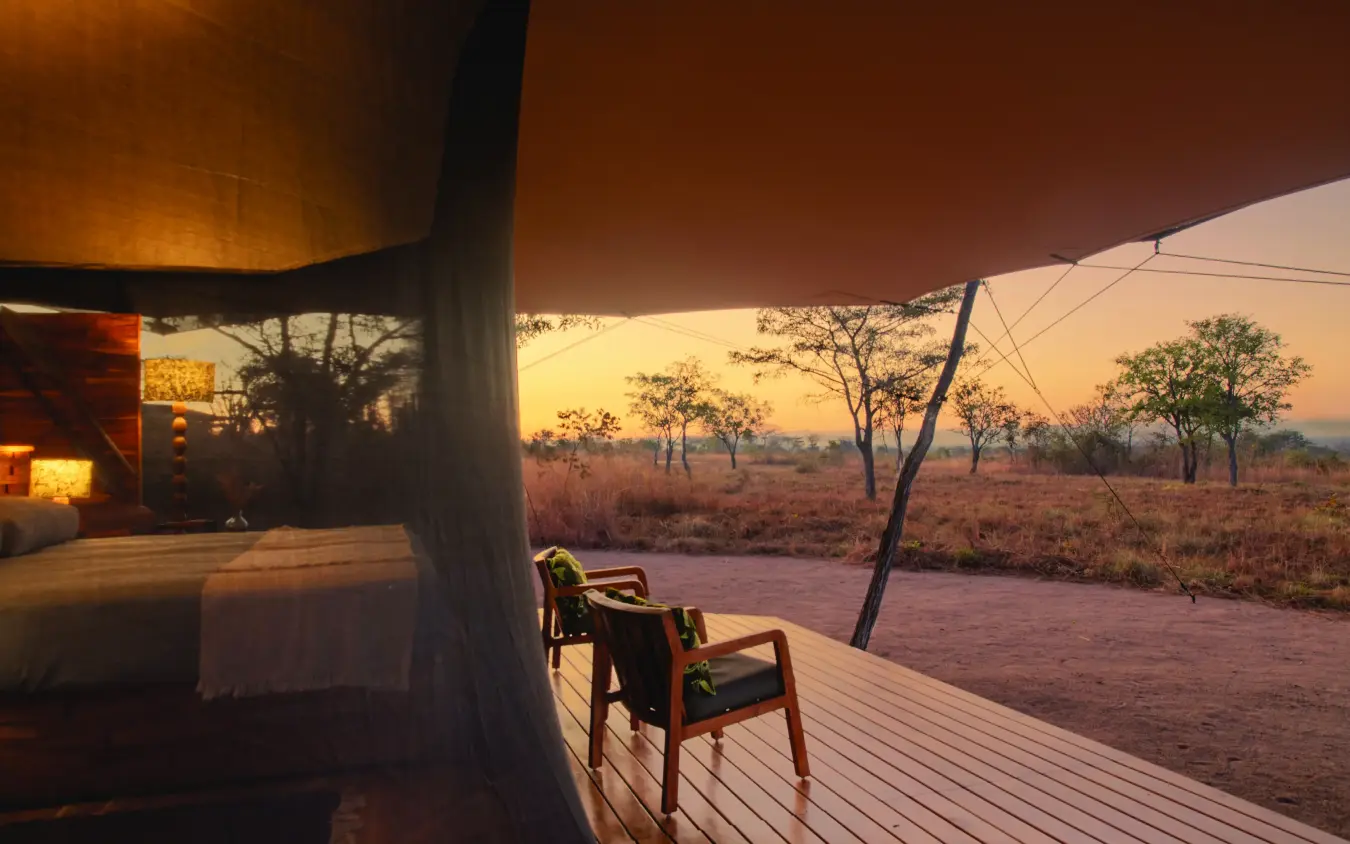Wooden deck overlooking African savanna at sunset, Usangu Expedition Camp, Ruaha National Park, Tanzania