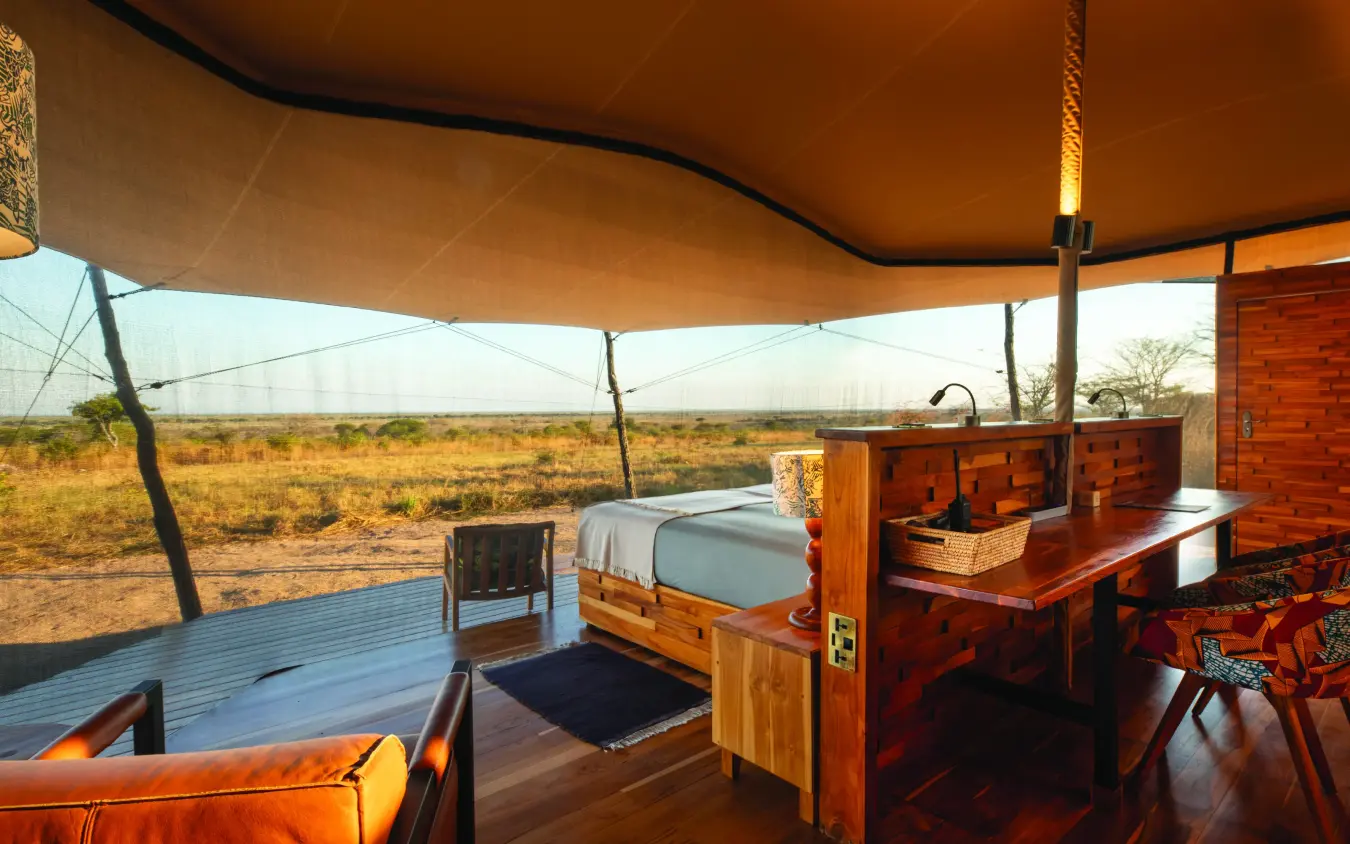Open-air bedroom tent with savanna landscape view, Usangu Expedition Camp, Ruaha National Park, Tanzania