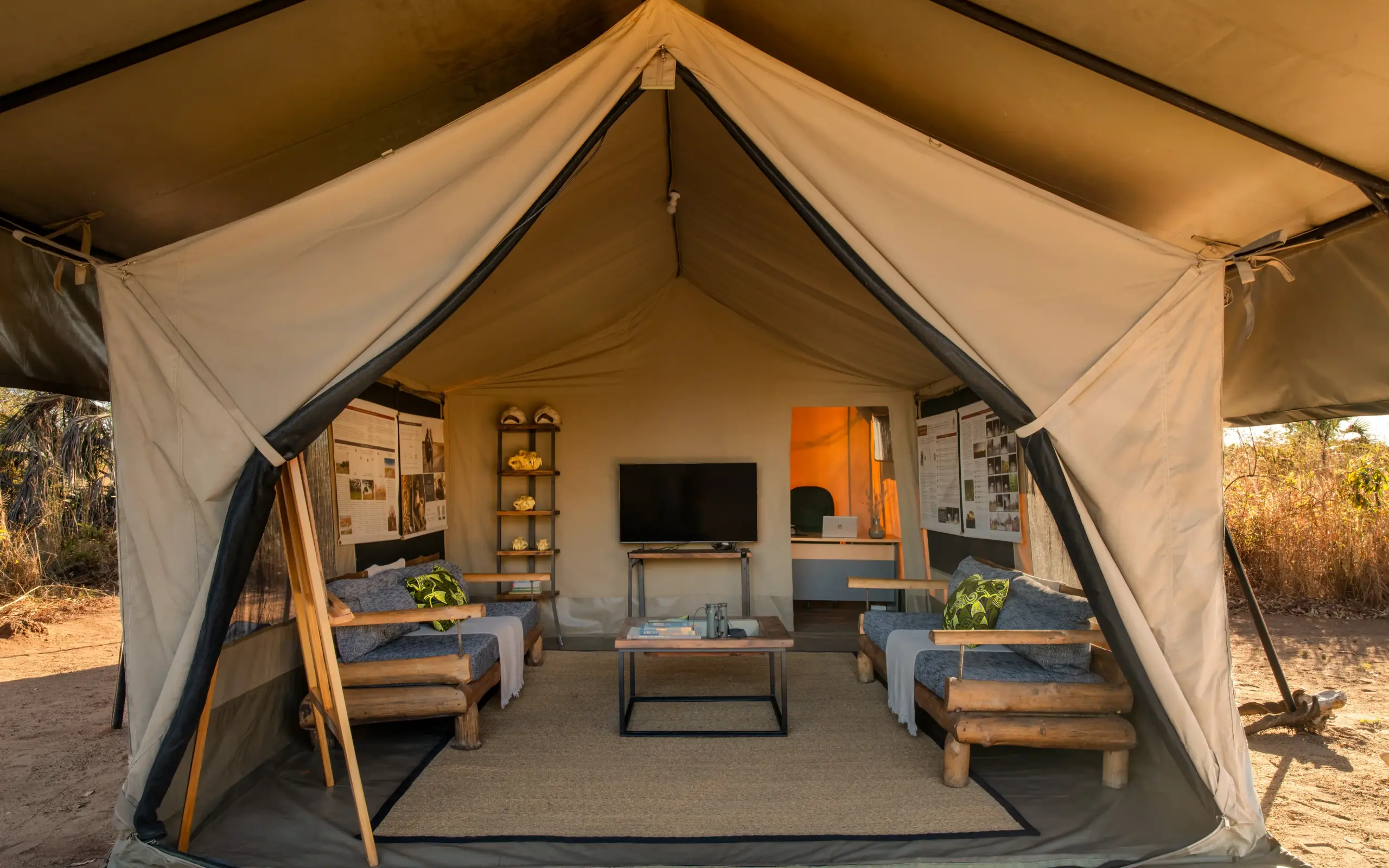 Safari tent interior with beds and entertainment setup, Usangu Expedition Camp, Ruaha National Park, Tanzania