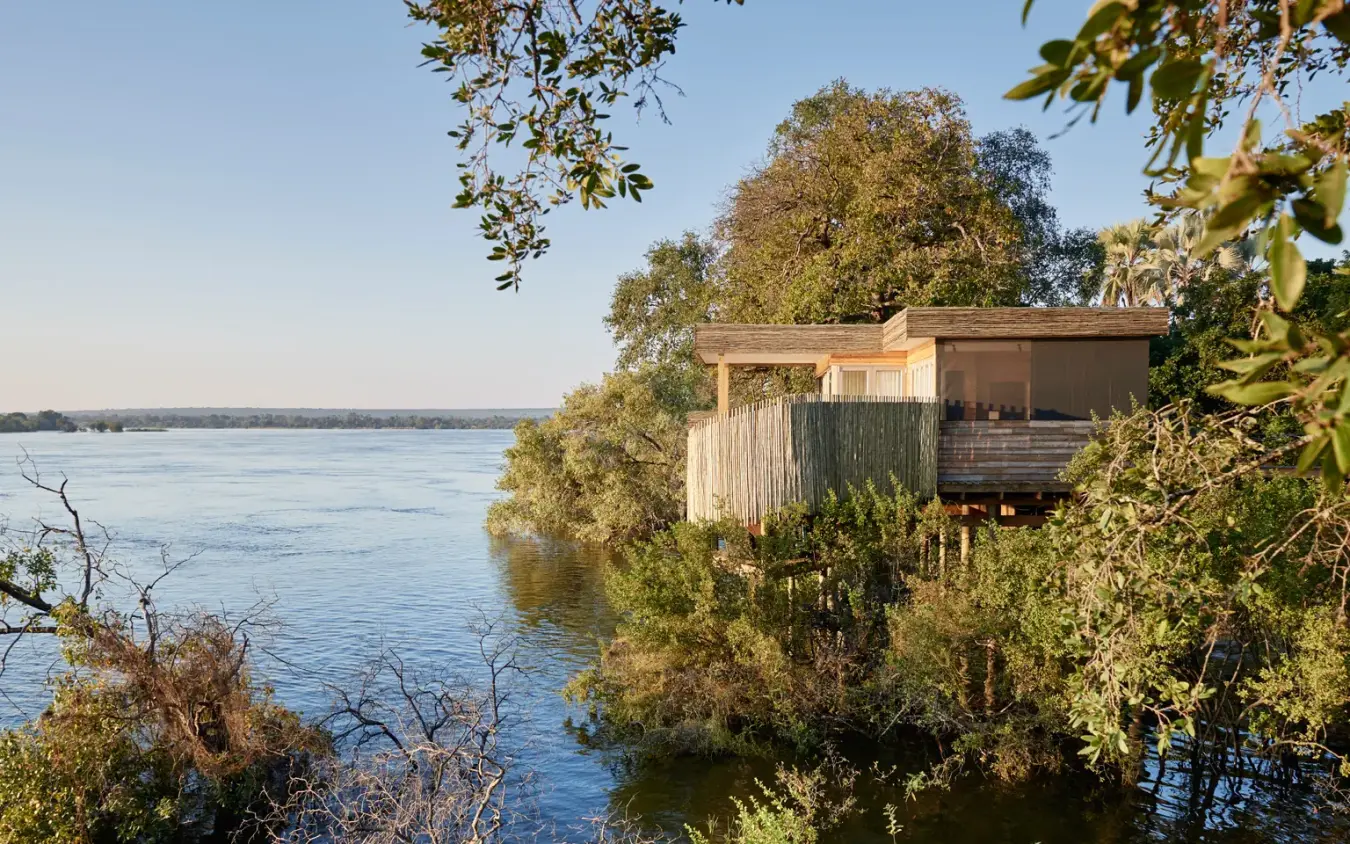 Wooden riverside lodge structure nestled among trees, Island Treehouse Suites, Victoria Falls, Zimbabwe