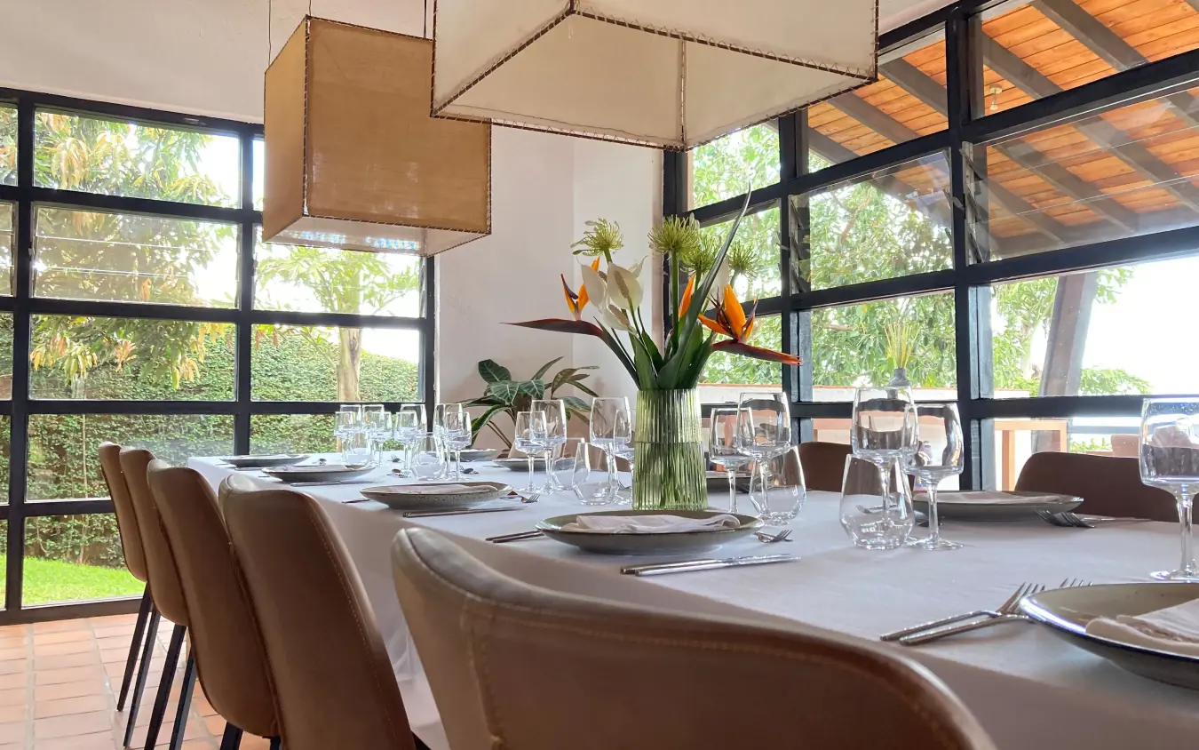 Elegant dining room with long table and garden views, Villa Kigali, Kigali, Rwanda