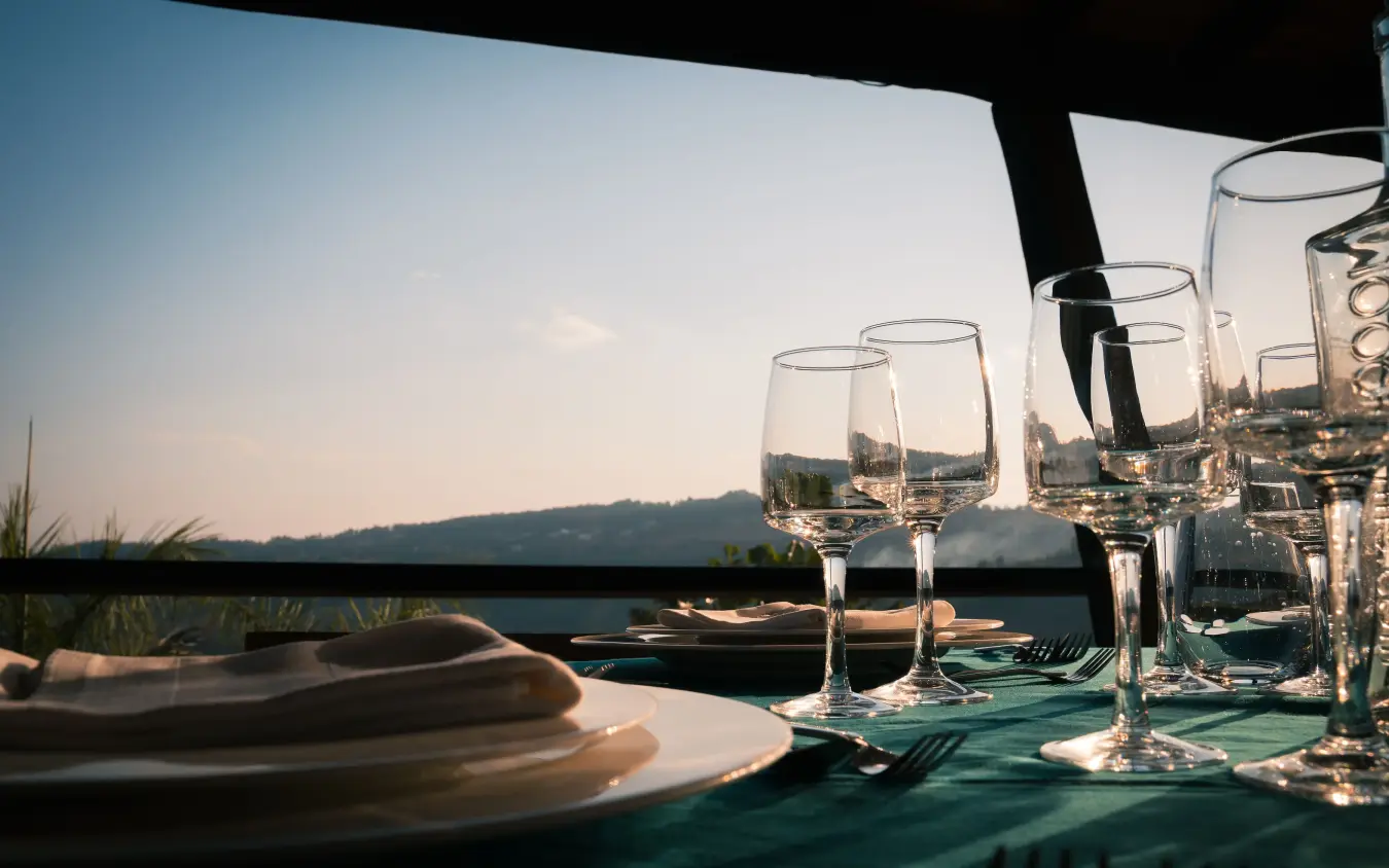 Fine dining table setting overlooking scenic landscape at sunset, Villa Kigali, Kigali, Rwanda