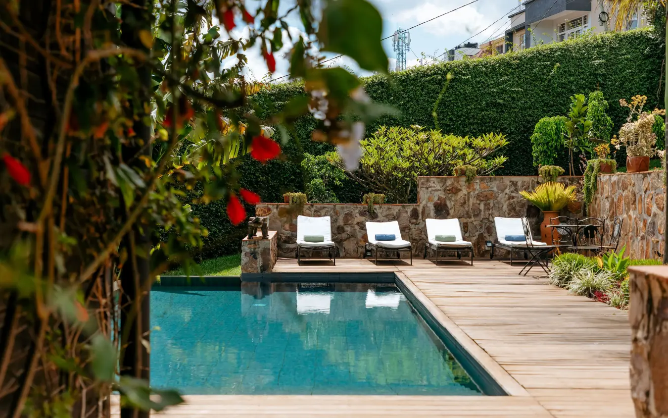 Swimming pool with loungers and manicured gardens, Villa Kigali, Kigali, Rwanda