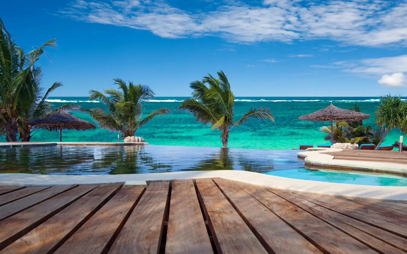 Wooden deck overlooking infinity pool and turquoise ocean, Waterlovers Beach Resort, Diani Beach, Kenya