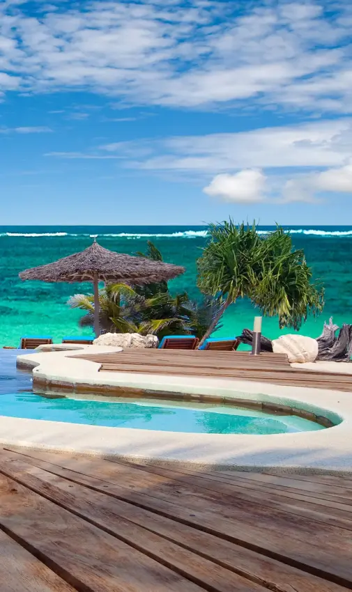 Wooden deck overlooking infinity pool and turquoise ocean, Waterlovers Beach Resort, Diani Beach, Kenya