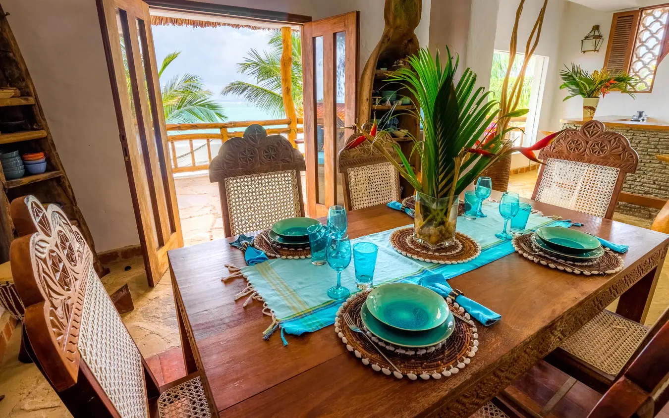 Dining table set with turquoise accents and ocean view, Waterlovers Beach Resort, Diani Beach, Kenya