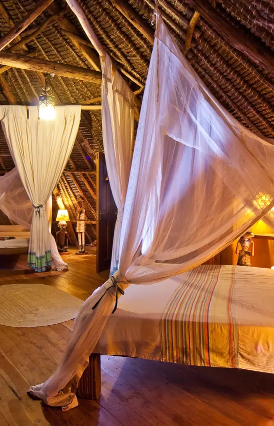 Luxury bedroom interior with draped canopy bed and wooden beams, Waterlovers Beach Resort, Diani Beach, Kenya
