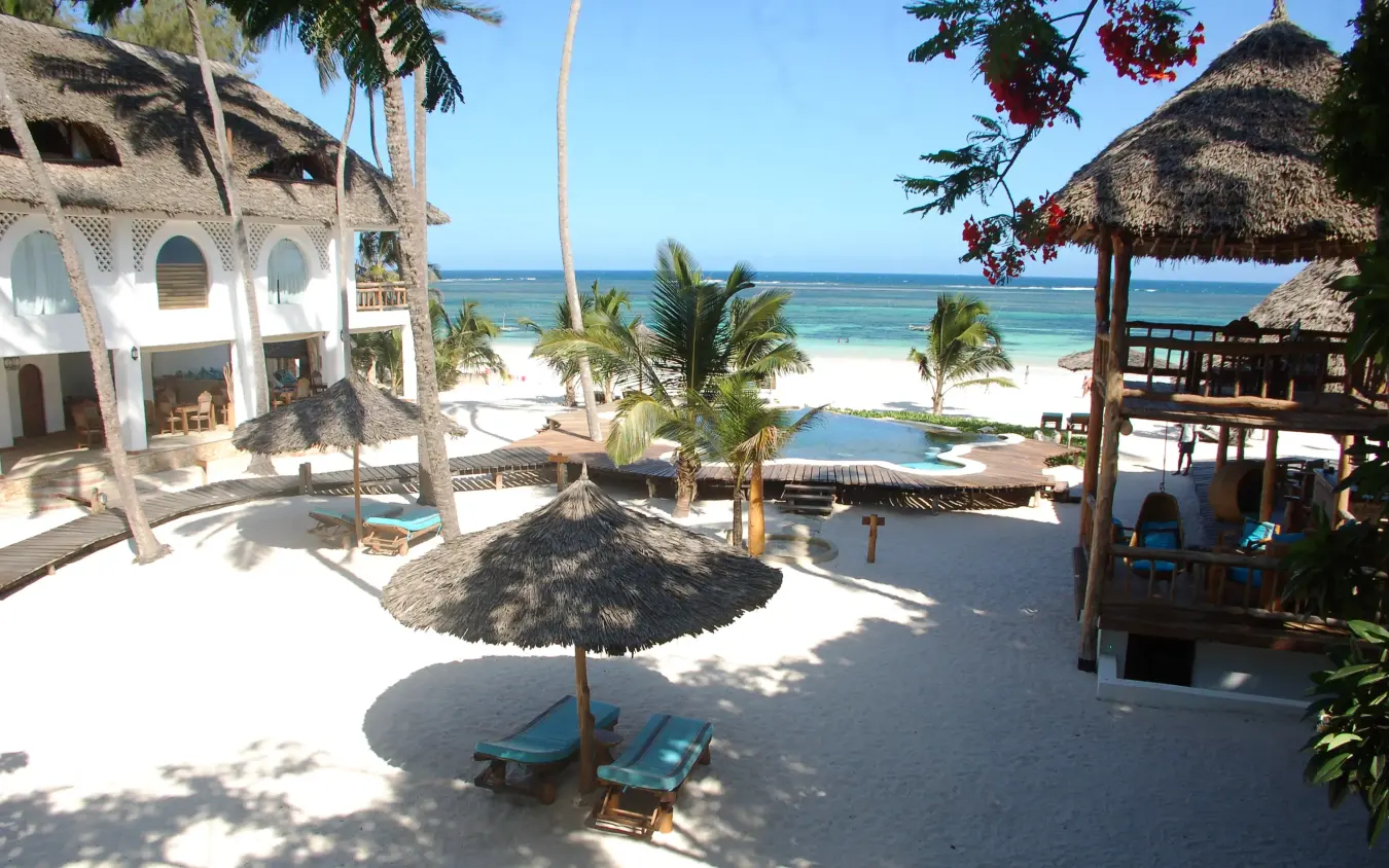 Beachfront lodge with thatched structures and white sand, Waterlovers Beach Resort, Diani Beach, Kenya