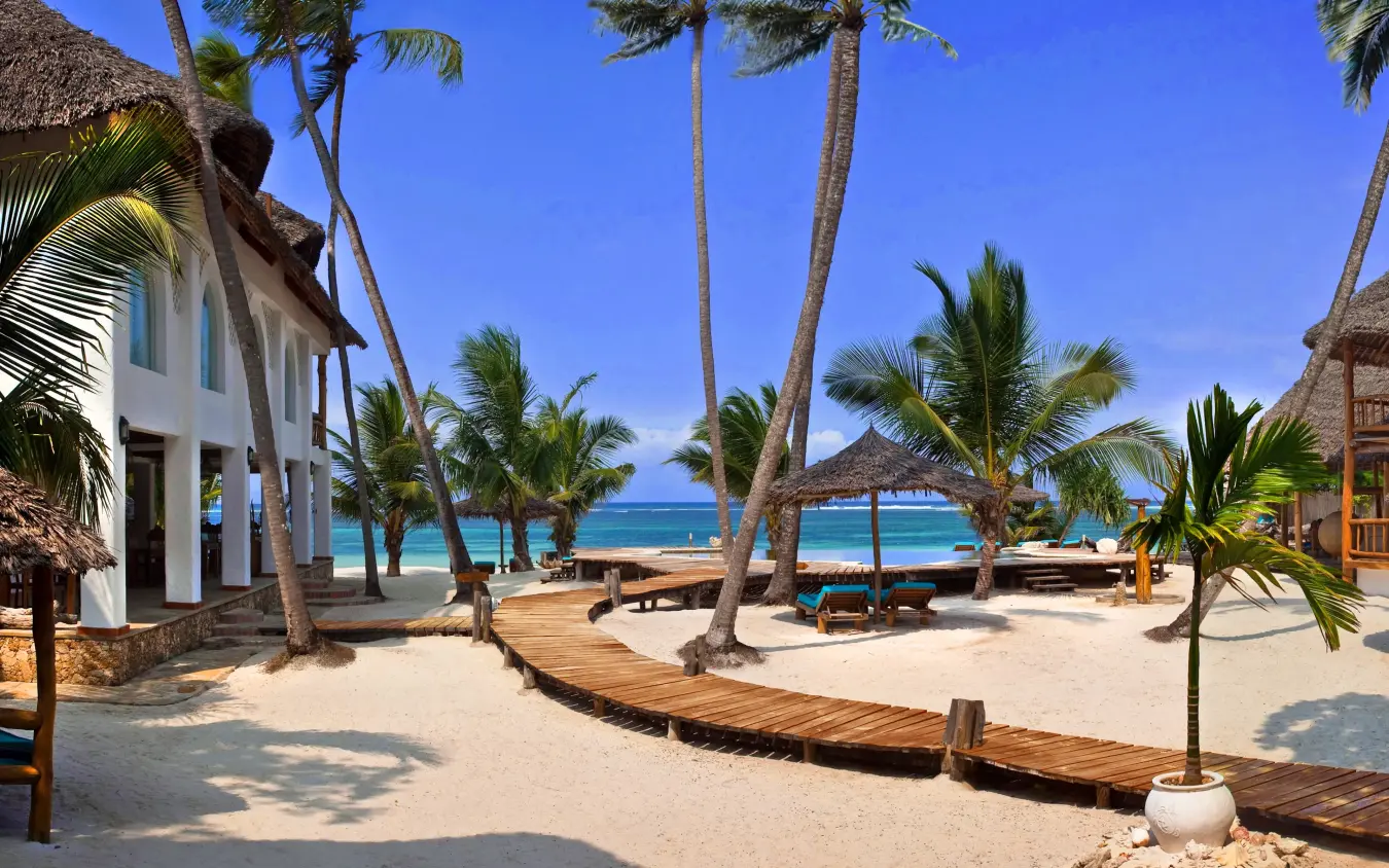 Beachfront lodge with palm trees and wooden structures, Waterlovers Beach Resort, Diani Beach, Kenya