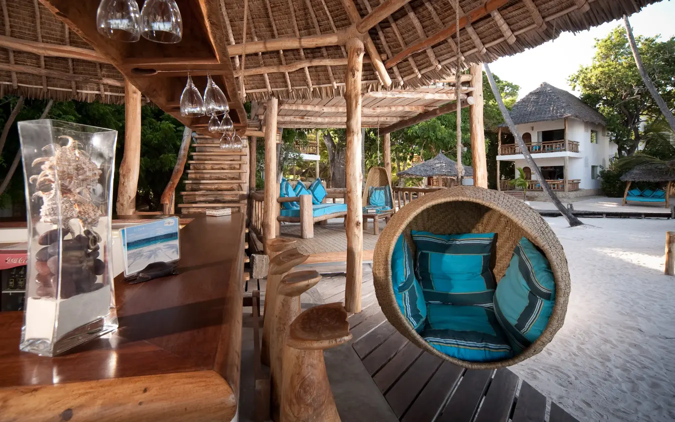 Wooden pavilion with blue seating and hanging lights overlooking grounds, Waterlovers Beach Resort, Diani Beach, Kenya