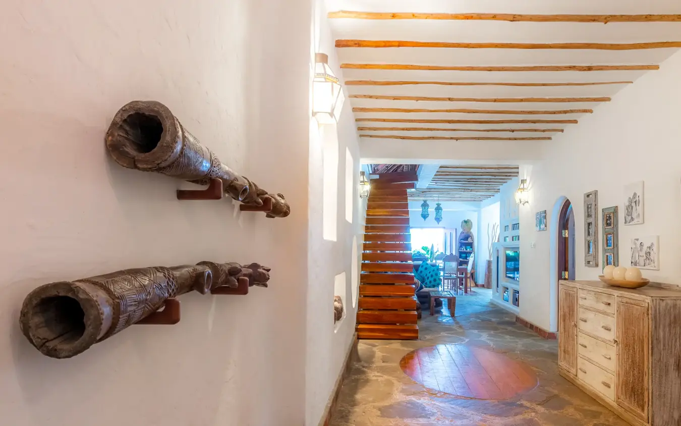 Interior hallway with wooden beams and carved artifacts, Waterlovers Beach Resort, Diani Beach, Kenya
