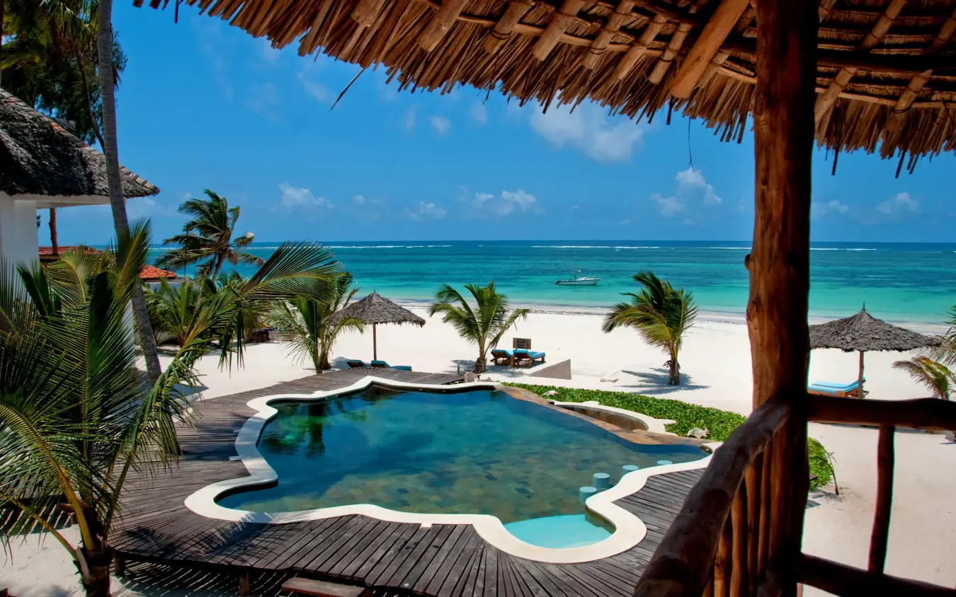 Beachfront pool overlooking turquoise ocean and white sand, Waterlovers Beach Resort, Diani Beach, Kenya