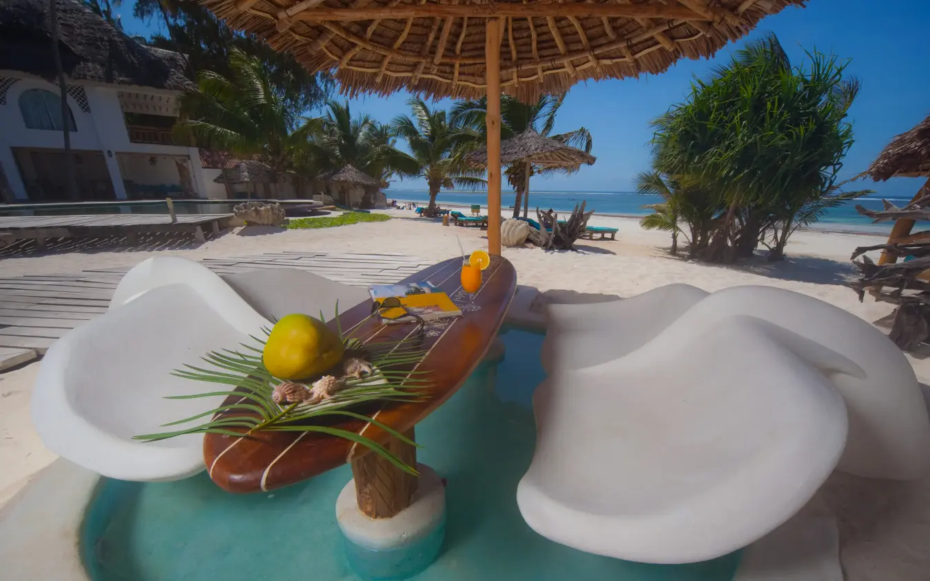 Beachfront pool area with lounge seating and ocean view, Waterlovers Beach Resort, Diani Beach, Kenya
