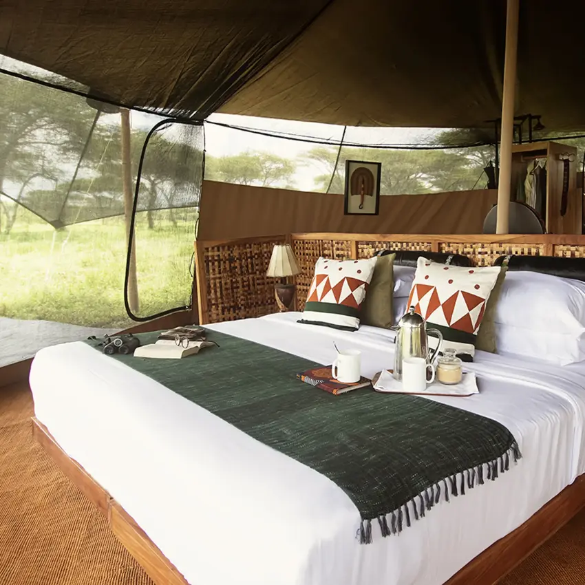 Safari tent bedroom with queen bed and canvas walls, Serengeti Green Camp, Serengeti National Park, Tanzania