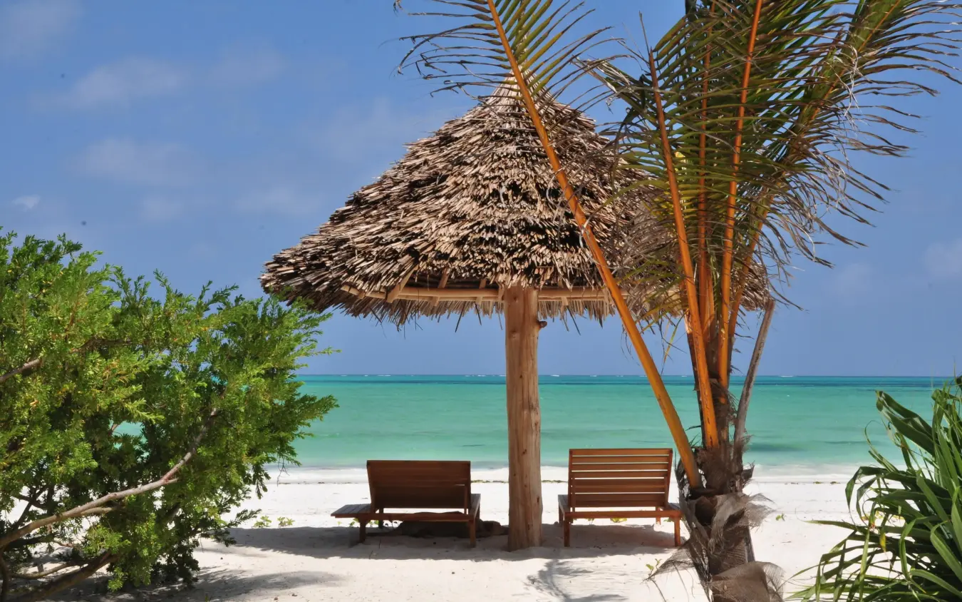 Thatched shelter with loungers facing turquoise ocean, White Sand Luxury Villas & Spa, Zanzibar & Pemba, Tanzania