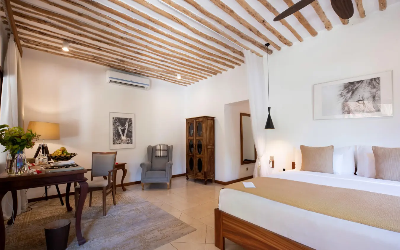 Spacious bedroom with wooden beamed ceiling and work area, White Sand Luxury Villas & Spa, Zanzibar & Pemba, Tanzania