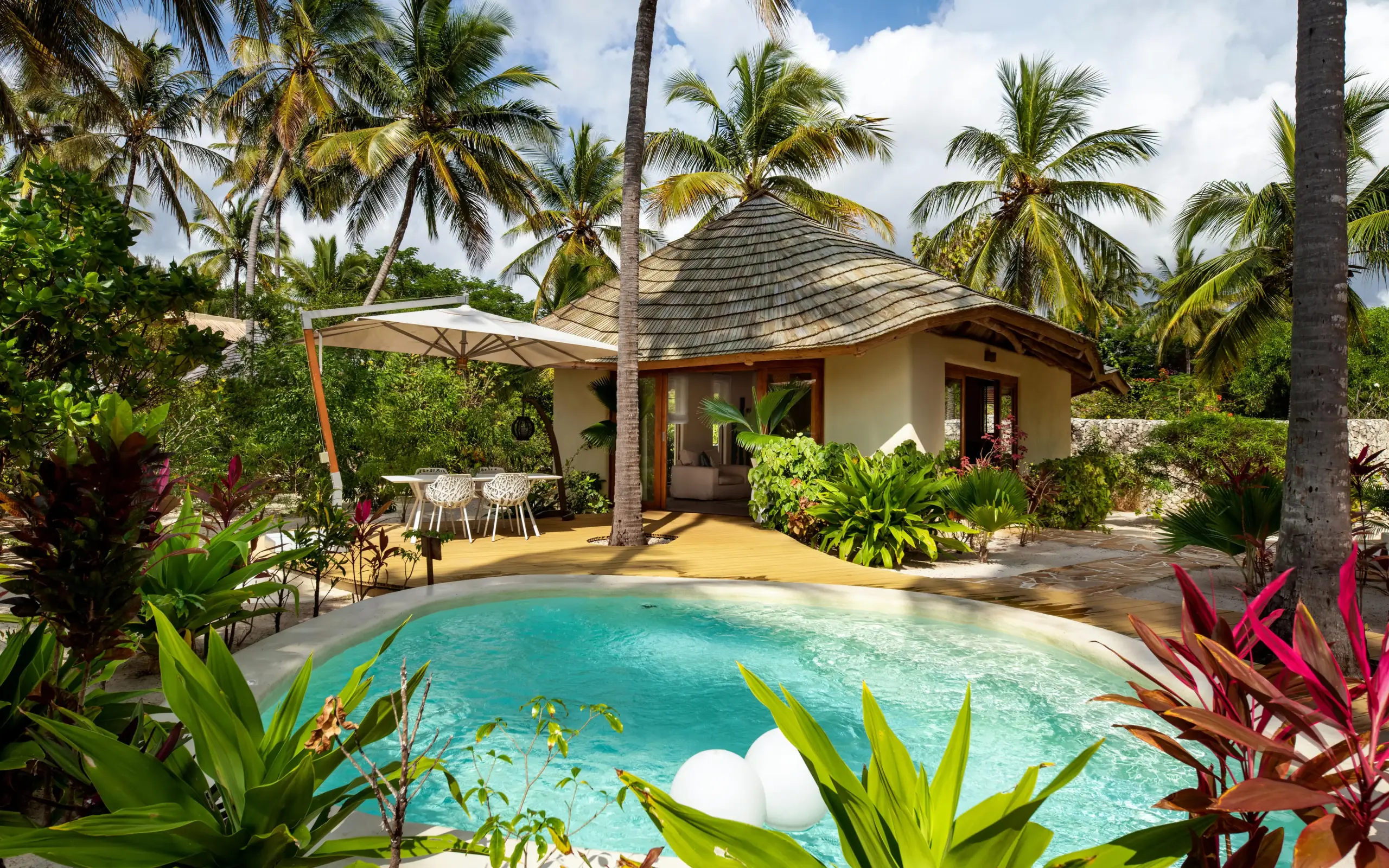 Private pool with thatched roof villa and palm trees, White Sand Luxury Villas & Spa, Zanzibar & Pemba, Tanzania