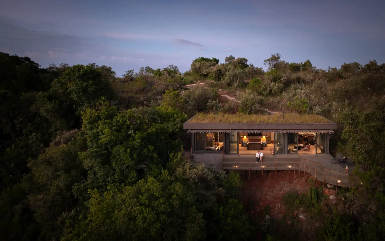 Modern lodge structure elevated above savanna woodland at dusk, Wild Hill, Maasai Mara, Kenya