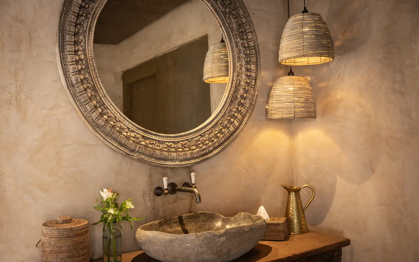 Bathroom vanity with stone sink and decorative mirror, Wild Hill, Maasai Mara, Kenya