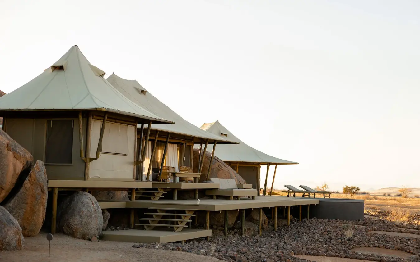 Canvas tent-style accommodation structures with boulder foundations, Wolwedans Boulders Camp, NamibRand Private Reserve, Namibia