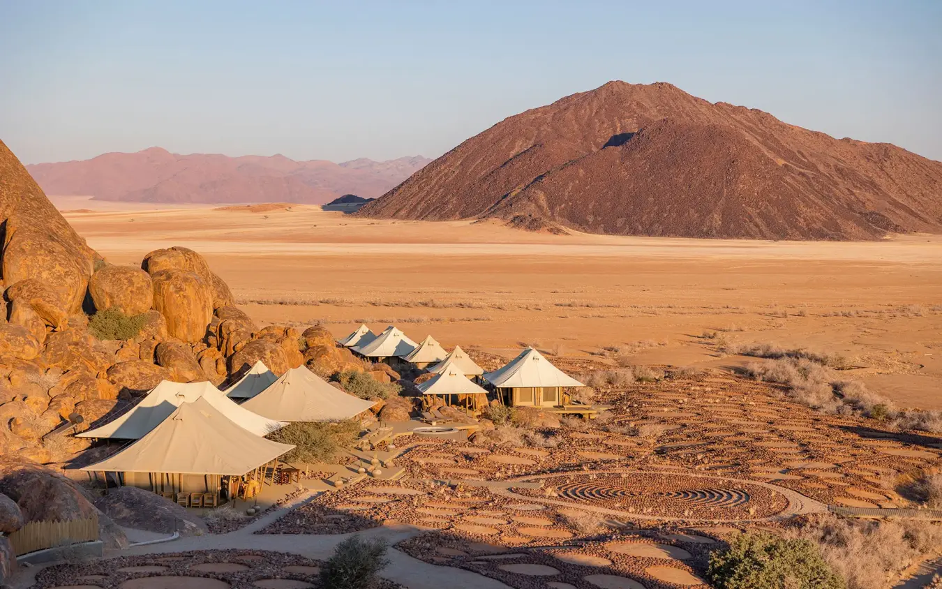 Desert camp with canvas tents nestled among boulders, Wolwedans Boulders Camp, NamibRand Private Reserve, Namibia