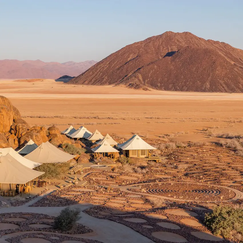 Desert camp with canvas tents nestled among boulders, Wolwedans Boulders Camp, NamibRand Private Reserve, Namibia