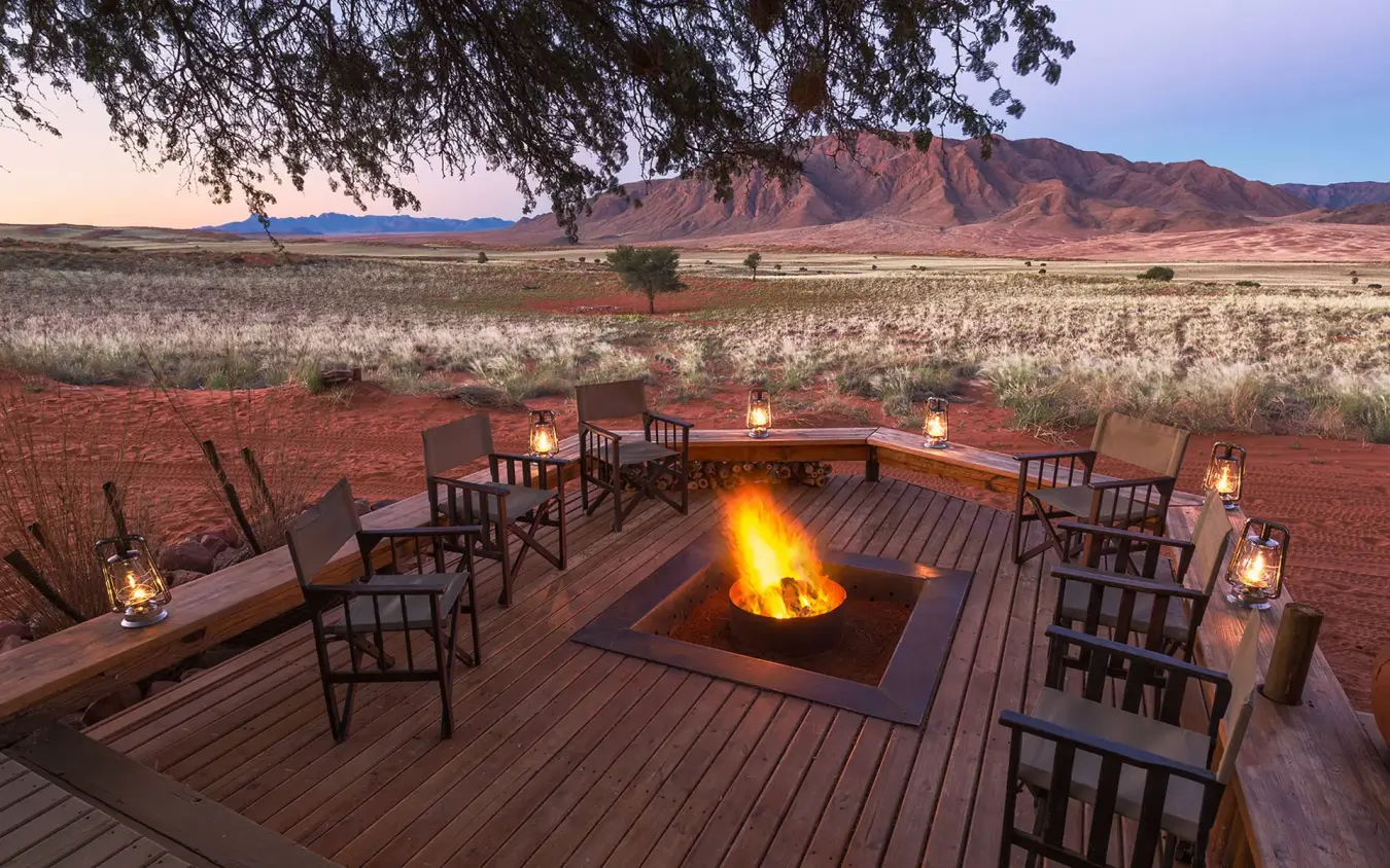 Evening fire pit with seating overlooking desert landscape, Wolwedans Dune Camp, NamibRand Private Reserve, Namibia