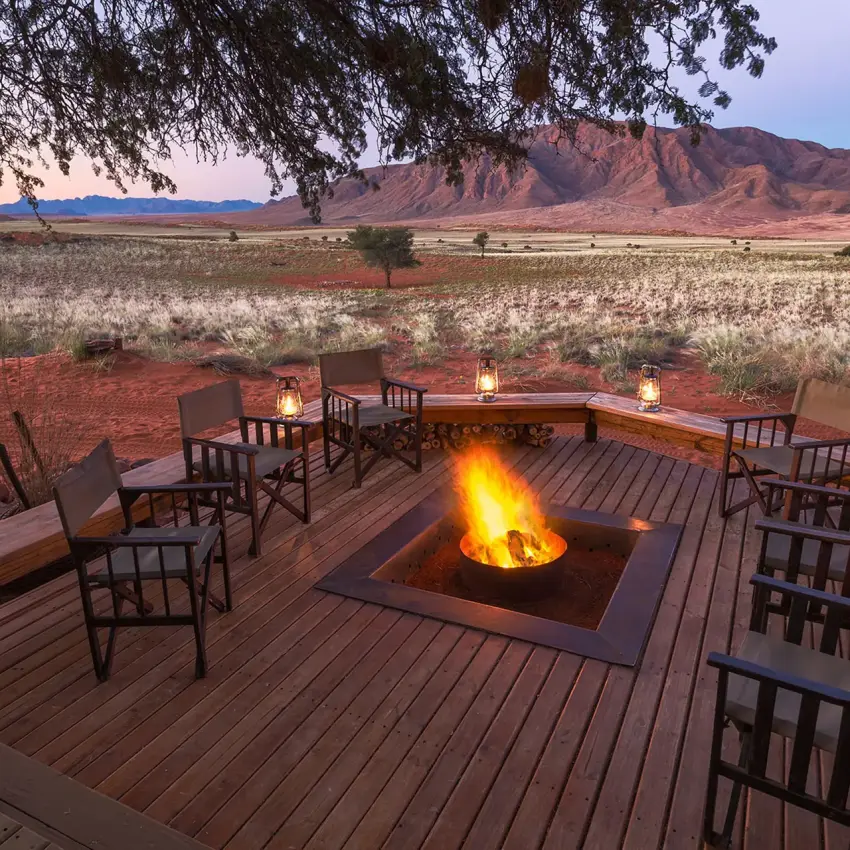 Evening fire pit with seating overlooking desert landscape, Wolwedans Dune Camp, NamibRand Private Reserve, Namibia