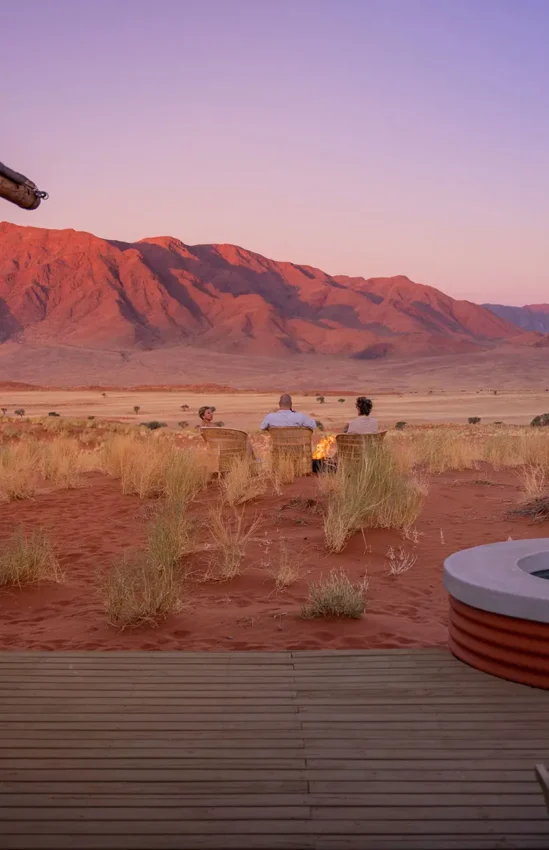 Wooden deck overlooking desert landscape at sunset, Wolwedans Dune Camp, NamibRand Private Reserve, Namibia