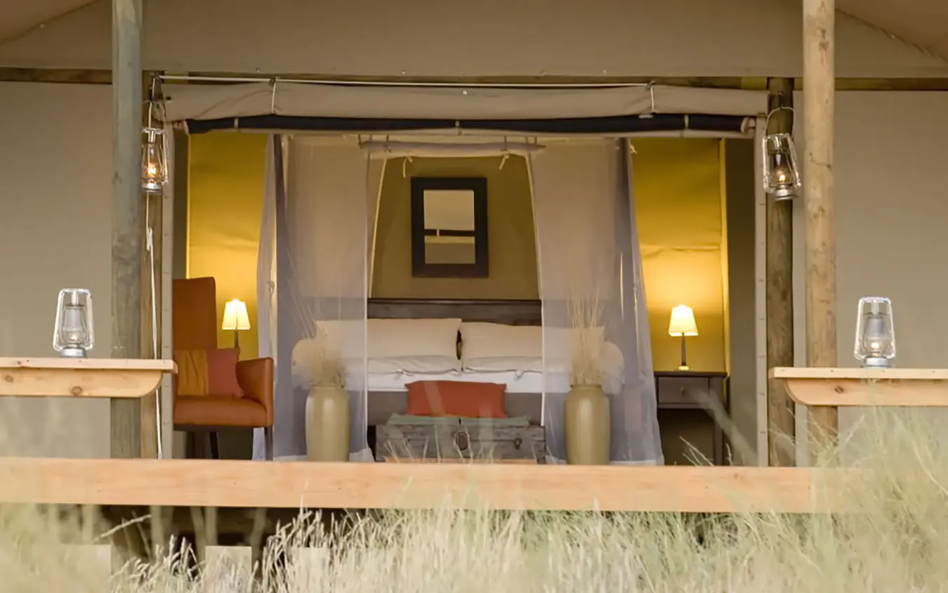 Luxury bedroom with canopy bed and desert views, Wolwedans Dune Camp, NamibRand Private Reserve, Namibia