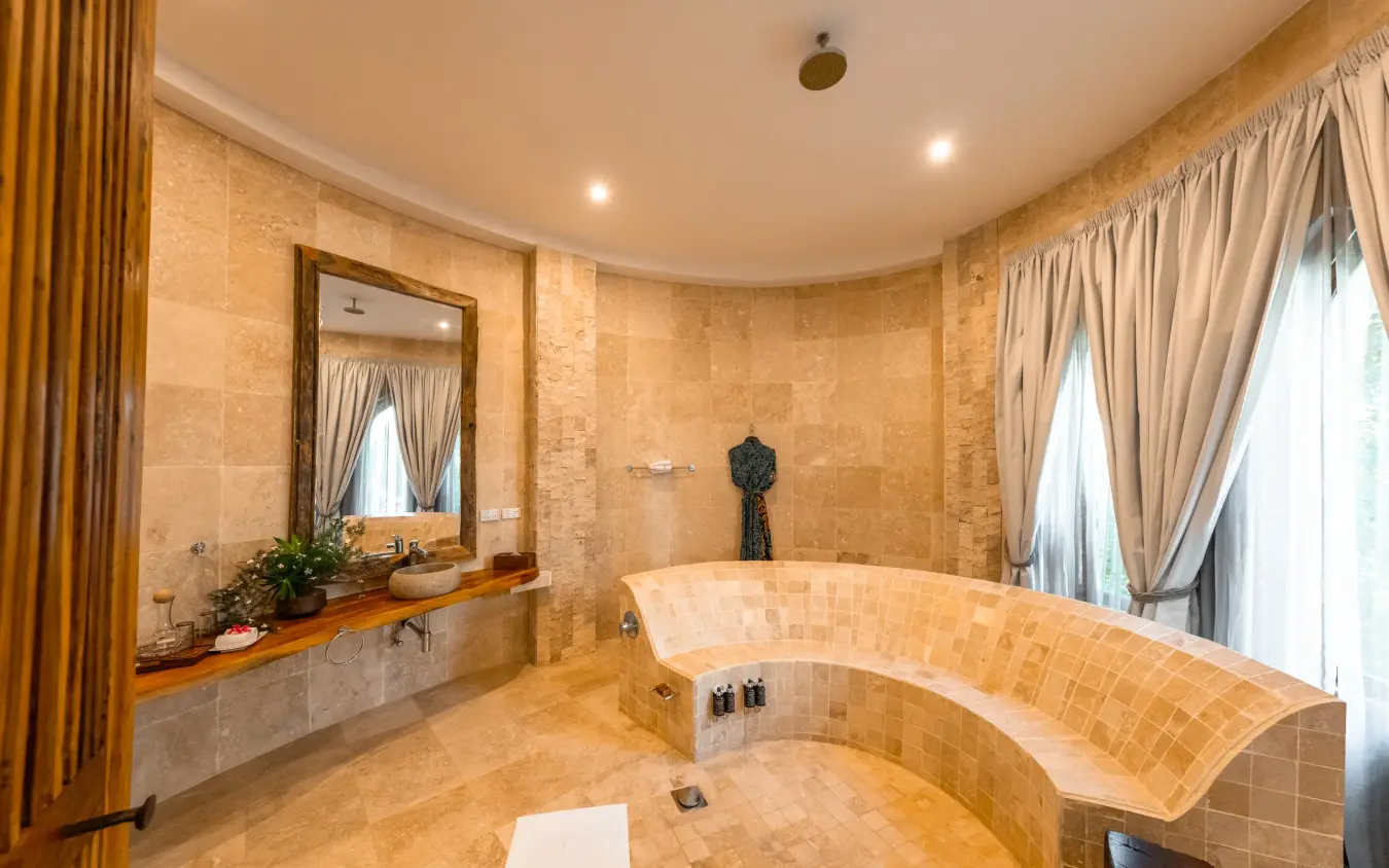 Luxurious bathroom with curved stone bathtub and dual vanity, Xanadu Villas, Zanzibar & Pemba, Tanzania