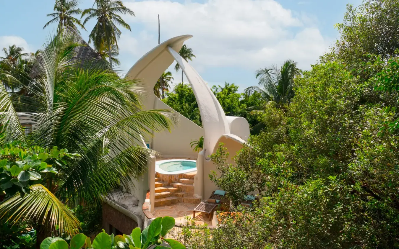 White curved architecture with pool surrounded by tropical vegetation, Xanadu Villas, Zanzibar & Pemba, Tanzania