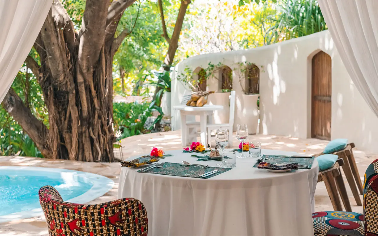 Outdoor dining area with pool and white architecture, Xanadu Villas, Zanzibar & Pemba, Tanzania