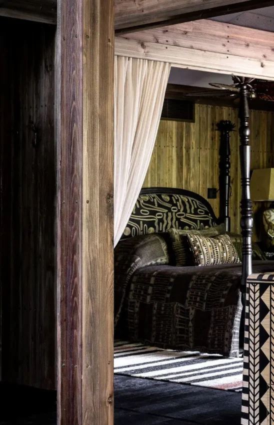 Bedroom with patterned dresser, lamp, and open doorway, Xigera Lodge, The Okavango Delta, Botswana