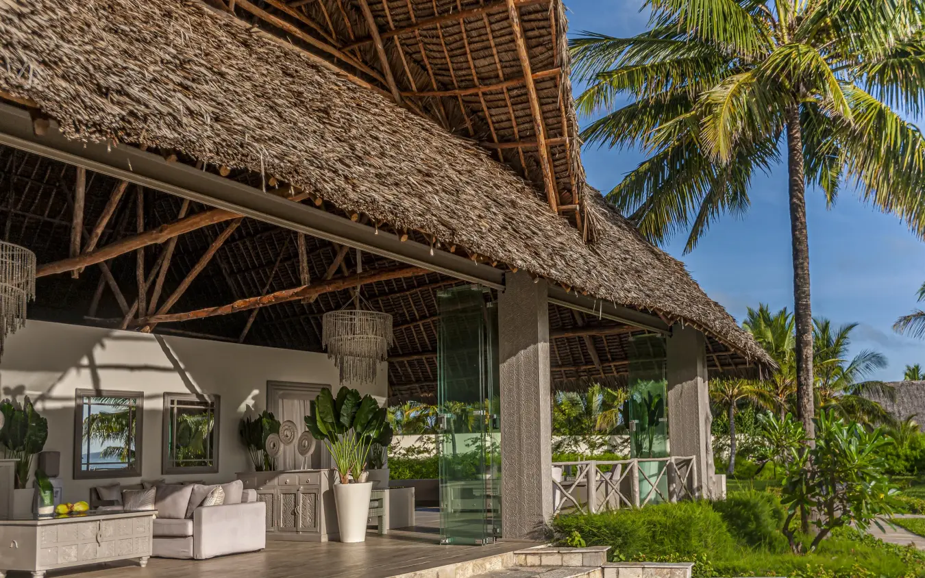Covered lounge area with thatched roof and palm trees, Zawadi Hotel, Zanzibar & Pemba, Tanzania