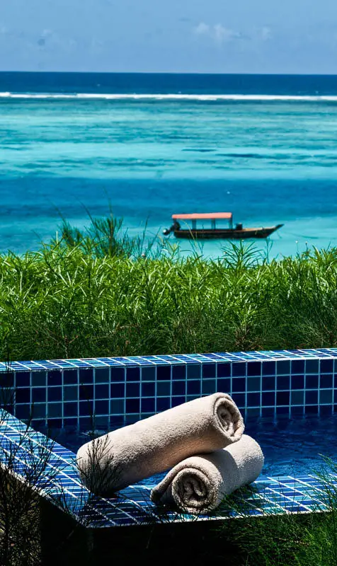 Oceanfront pool with rolled towels and turquoise water view, Zawadi Hotel, Zanzibar & Pemba, Tanzania