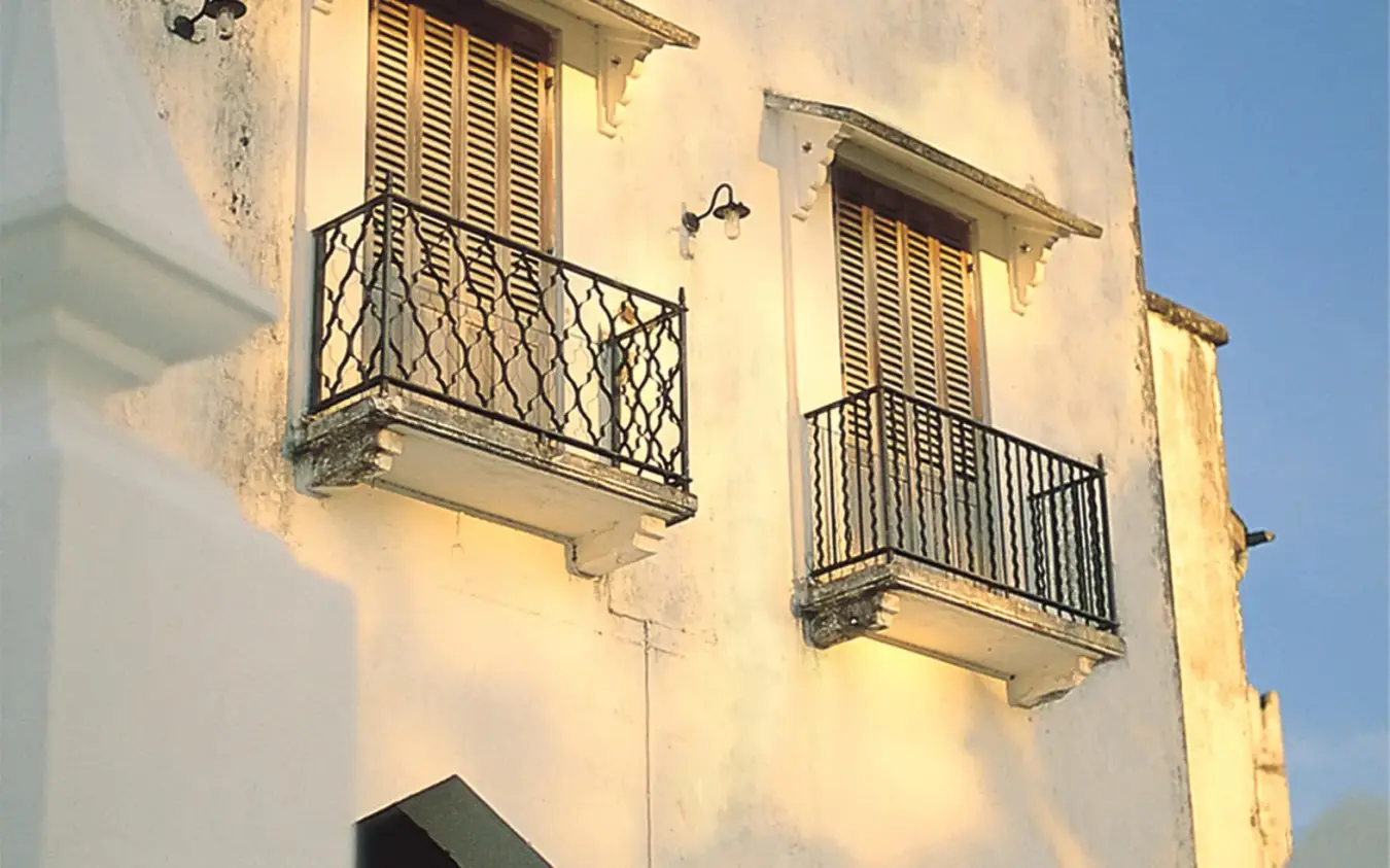 Colonial architecture with weathered facade and ornate iron balconies, Baraza Resort and Spa, Zanzibar & Pemba, Tanzania