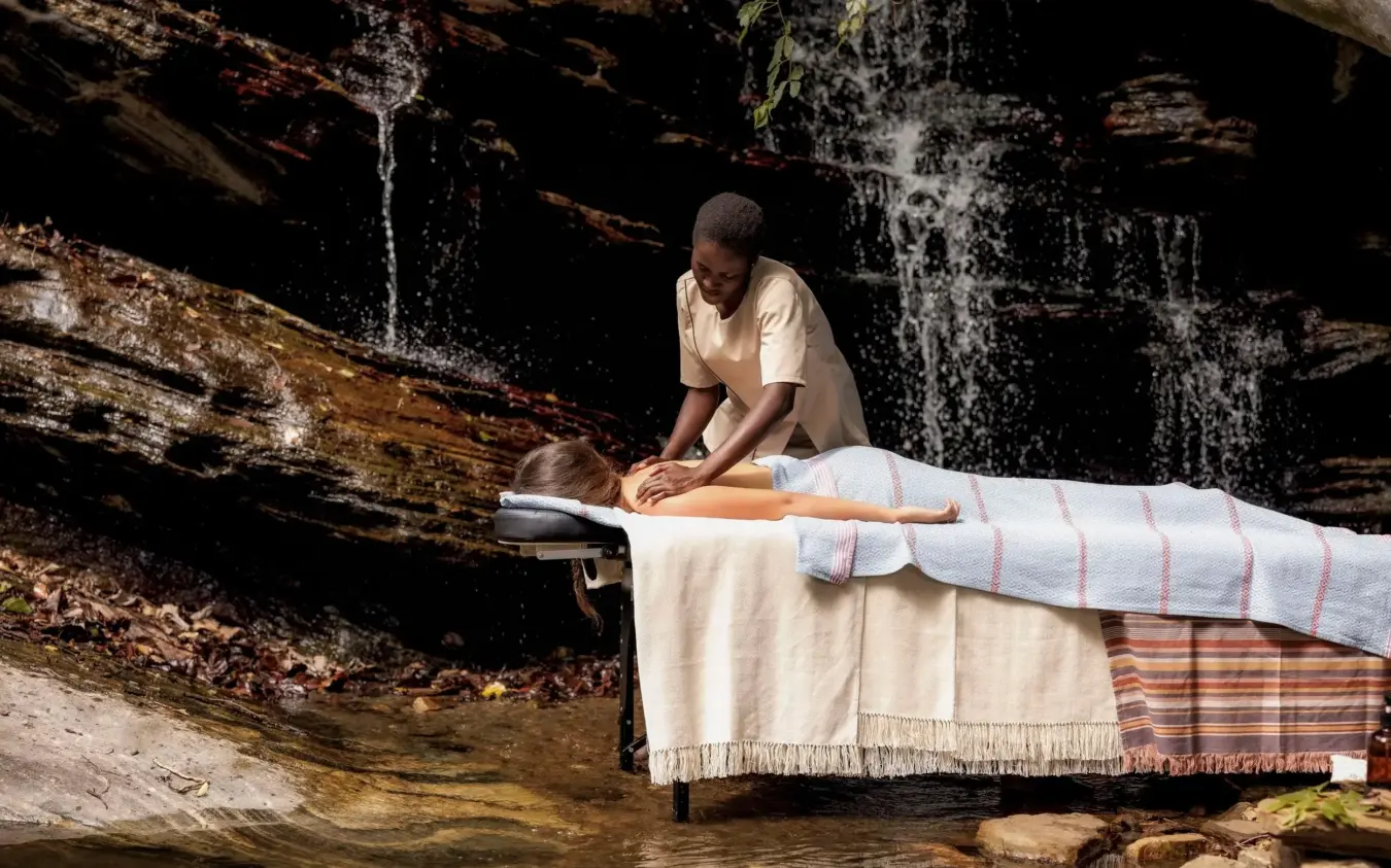 Outdoor massage at waterfall with natural rock backdrop, Desert Rose, Northern Kenya, Kenya