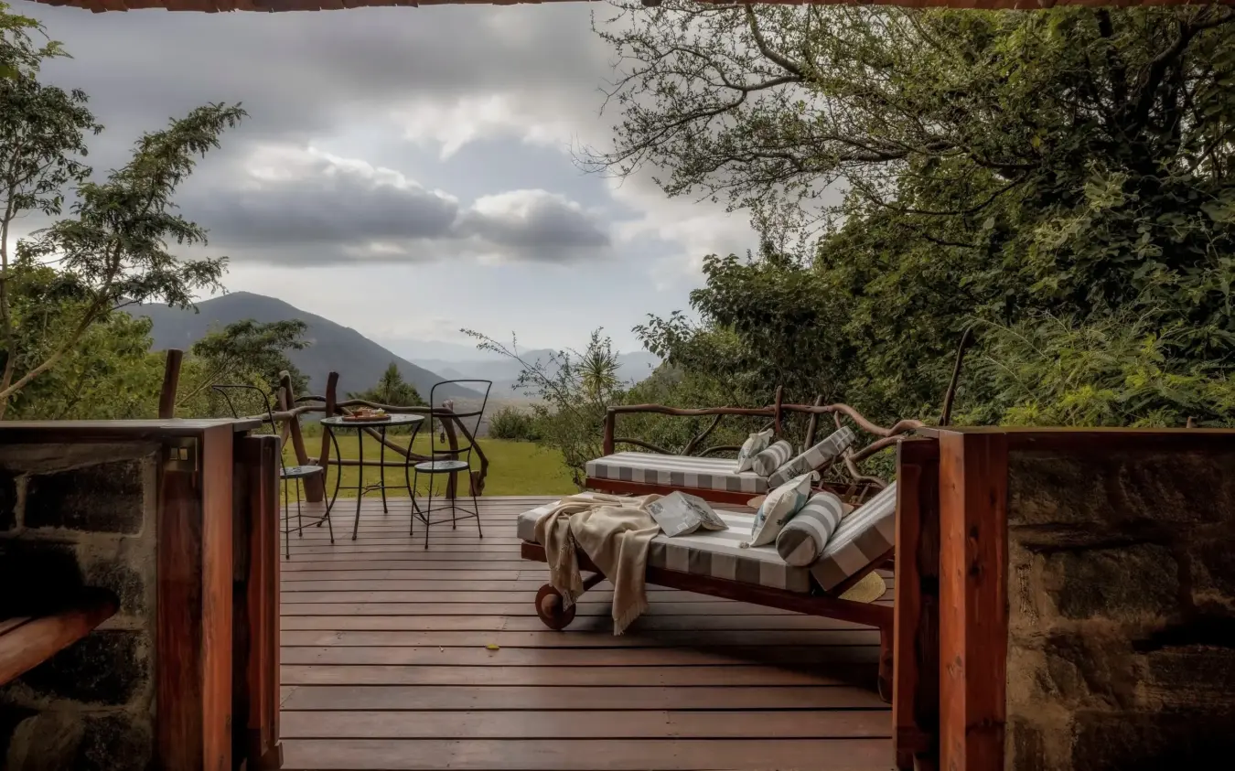 Wooden deck with daybed and mountain view at sunset, Desert Rose, Northern Kenya, Kenya