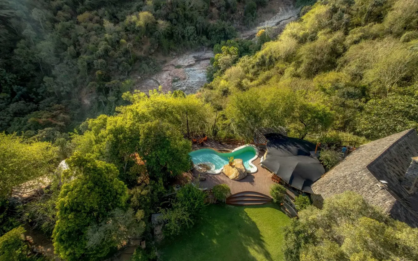 Luxury lodge with pool overlooking river canyon surrounded by dense forest, Desert Rose, Northern Kenya, Kenya