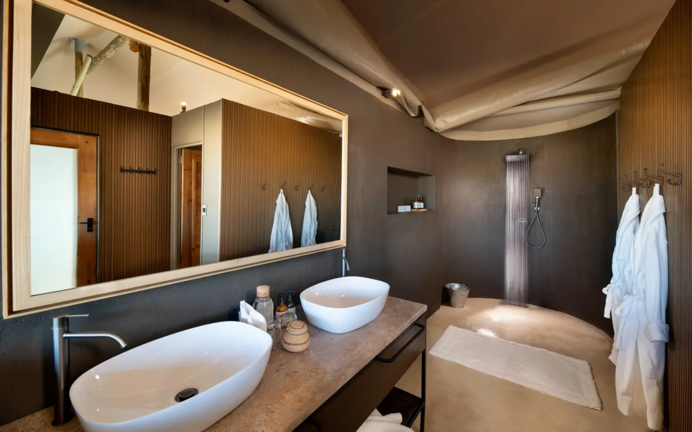 Luxury bathroom with dual vessel sinks and walk-in shower, Hoanib Elephant Camp, Skeleton Coast, Namibia
