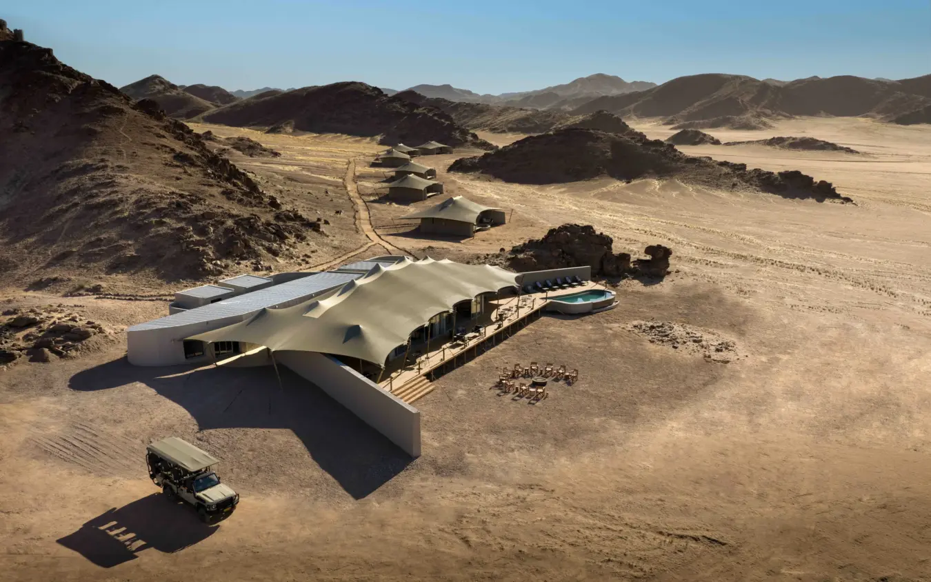 Modern lodge with curved architecture nestled in desert landscape, Hoanib Elephant Camp, Skeleton Coast, Namibia