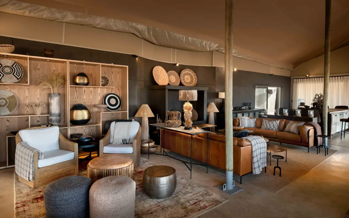 Luxury glamping tent interior with wooden furnishings and earth tones, Hoanib Elephant Camp, Skeleton Coast, Namibia