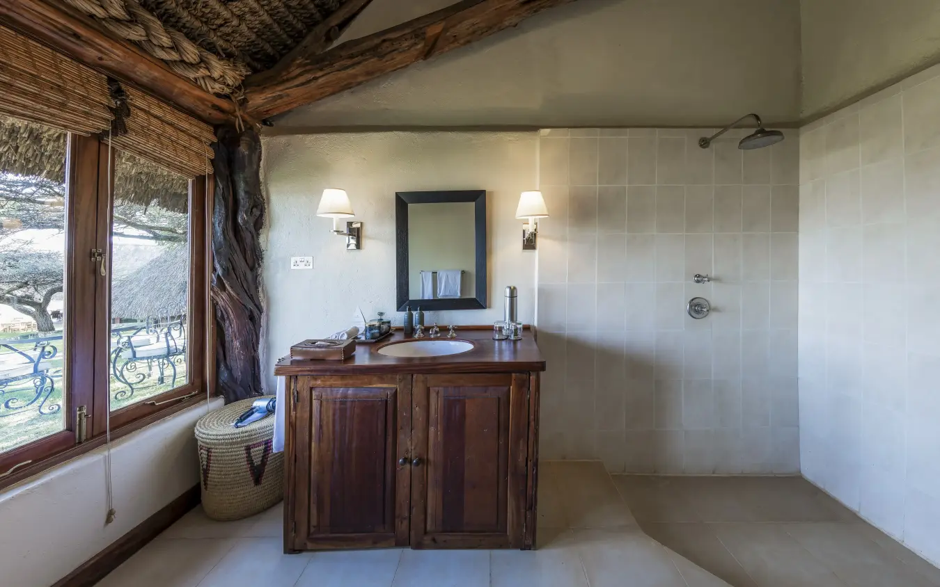 Luxury safari bathroom with wooden vanity and scenic valley views, Kifaru House, Laikipia Highlands, Kenya